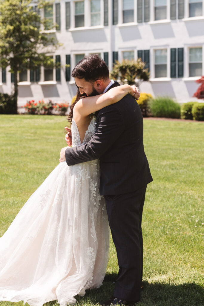 Bride and groom share a hug outside venue. Wedding day at Blue Heron Pines Golf Club in Egg Harbor, NJ. Photographed by South Jersey/Philly based wedding photographer Madison Neumann Photography.