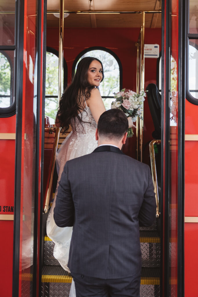 Bride and groom walk on to red trolley. Wedding day at Blue Heron Pines Golf Club in Egg Harbor, NJ. Photographed by South Jersey/Philly based wedding photographer Madison Neumann Photography.