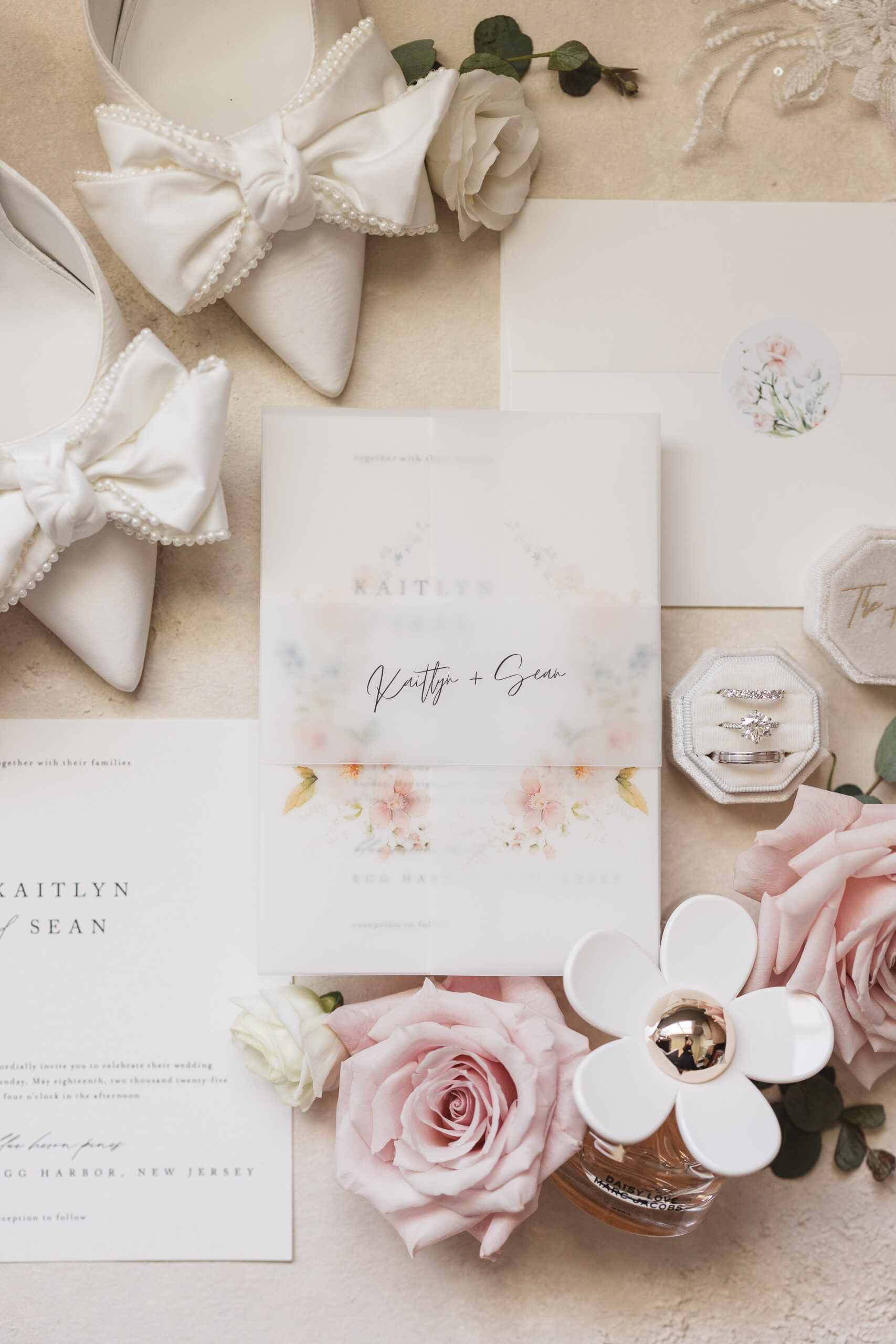 Flat lay photograph of wedding invitation suite, rings, bridal shoes, and flower details. Wedding day at Blue Heron Pines Golf Club in Egg Harbor, NJ. Photographed by South Jersey/Philly based wedding photographer Madison Neumann Photography.