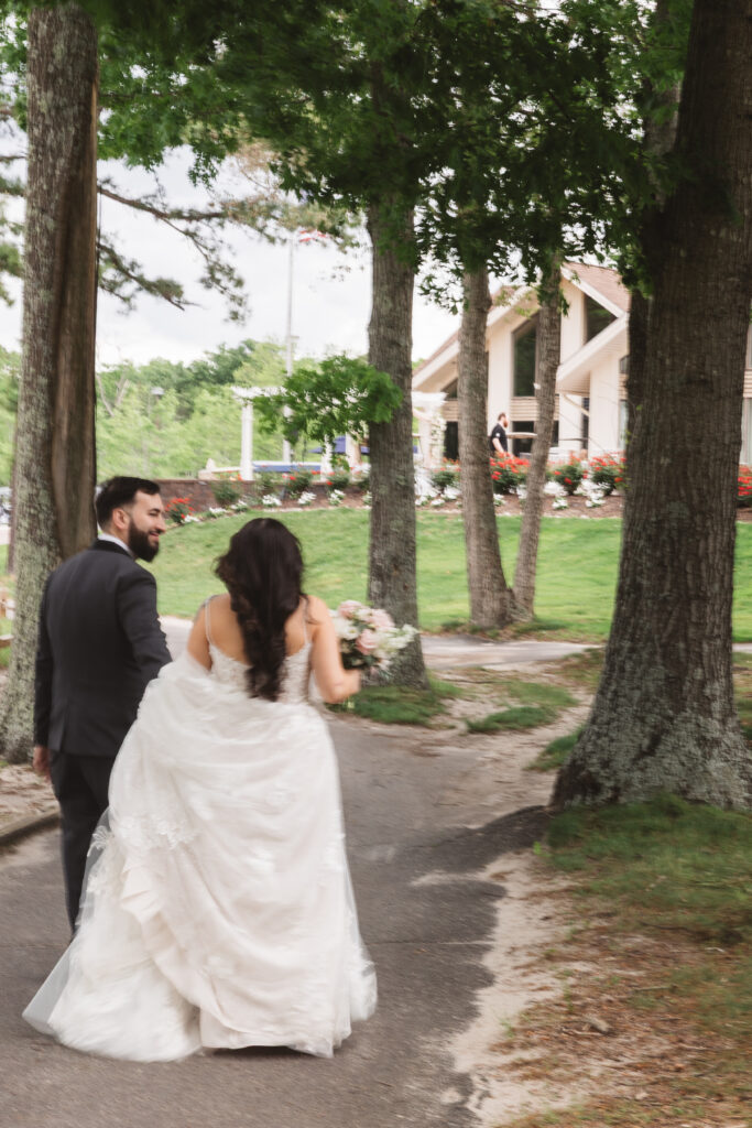 Bride and groom walk together through the trees of their venue. Wedding day at Blue Heron Pines Golf Club in Egg Harbor, NJ. Photographed by South Jersey/Philly based wedding photographer Madison Neumann Photography.