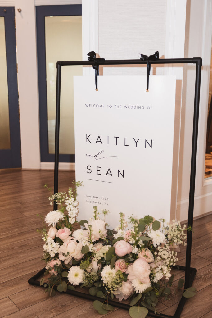 Custom welcome wedding sign and flowers. Wedding day at Blue Heron Pines Golf Club in Egg Harbor, NJ. Photographed by South Jersey/Philly based wedding photographer Madison Neumann Photography.