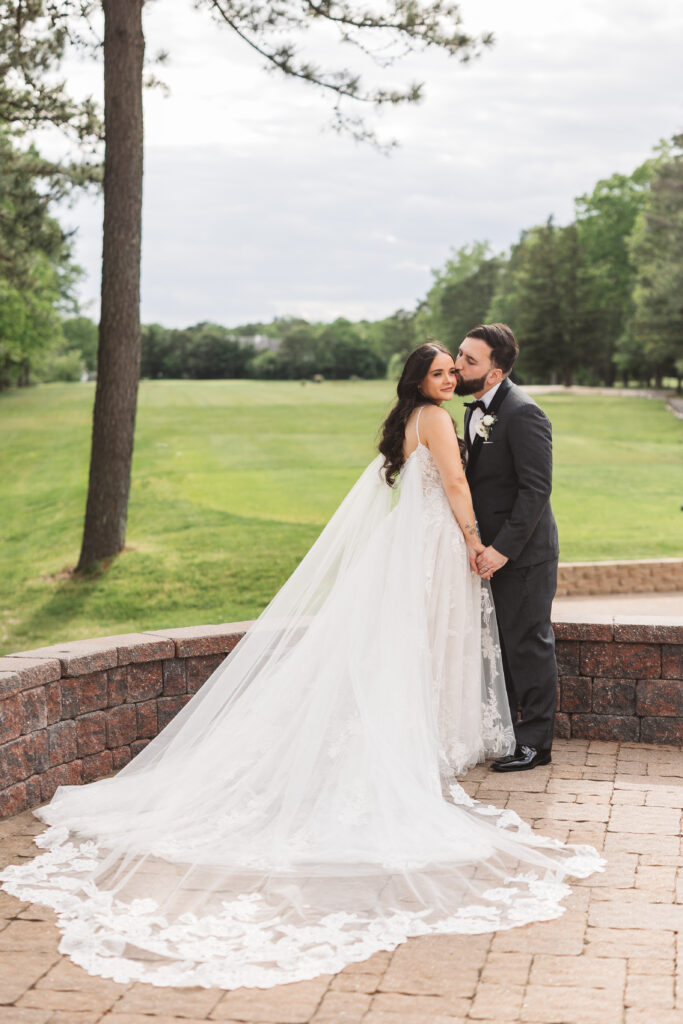Bride and groom stand together on brick patio. Wedding day at Blue Heron Pines Golf Club in Egg Harbor, NJ. Photographed by South Jersey/Philly based wedding photographer Madison Neumann Photography.