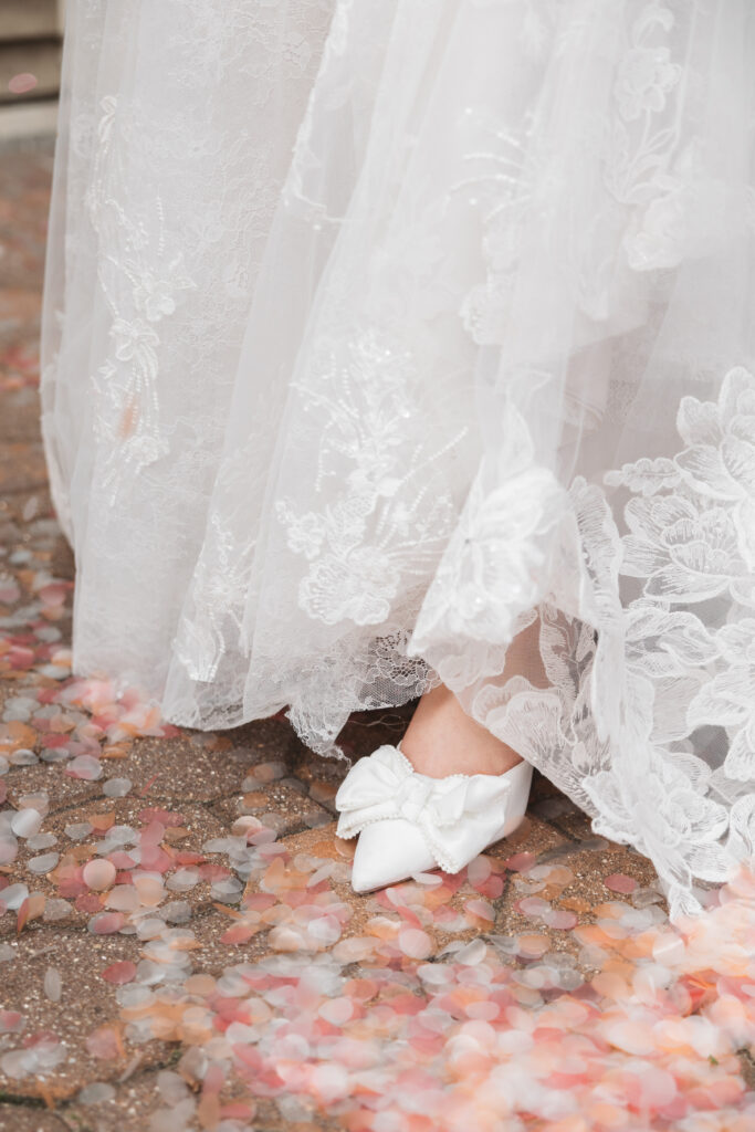 Bride's shoe walking on confetti on the ground. Wedding day at Blue Heron Pines Golf Club in Egg Harbor, NJ. Photographed by South Jersey/Philly based wedding photographer Madison Neumann Photography.