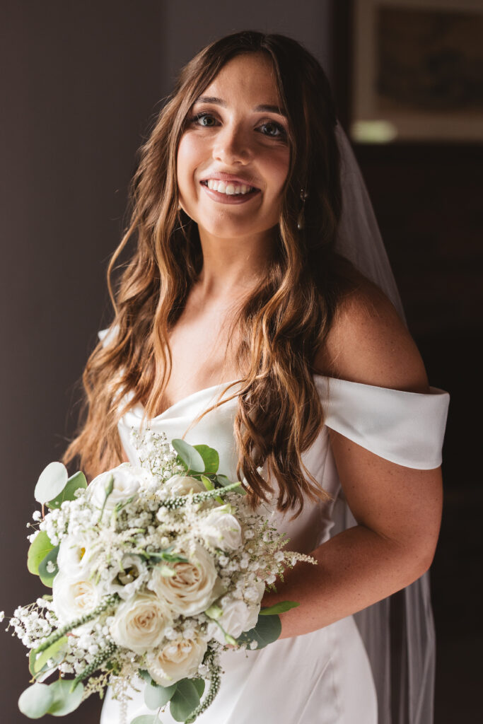 Portrait of bride holding her bouquet in bridal suite before first look, photographed by New Jersey and Philadelphia based travel wedding photographer Madison Neumann Photography.