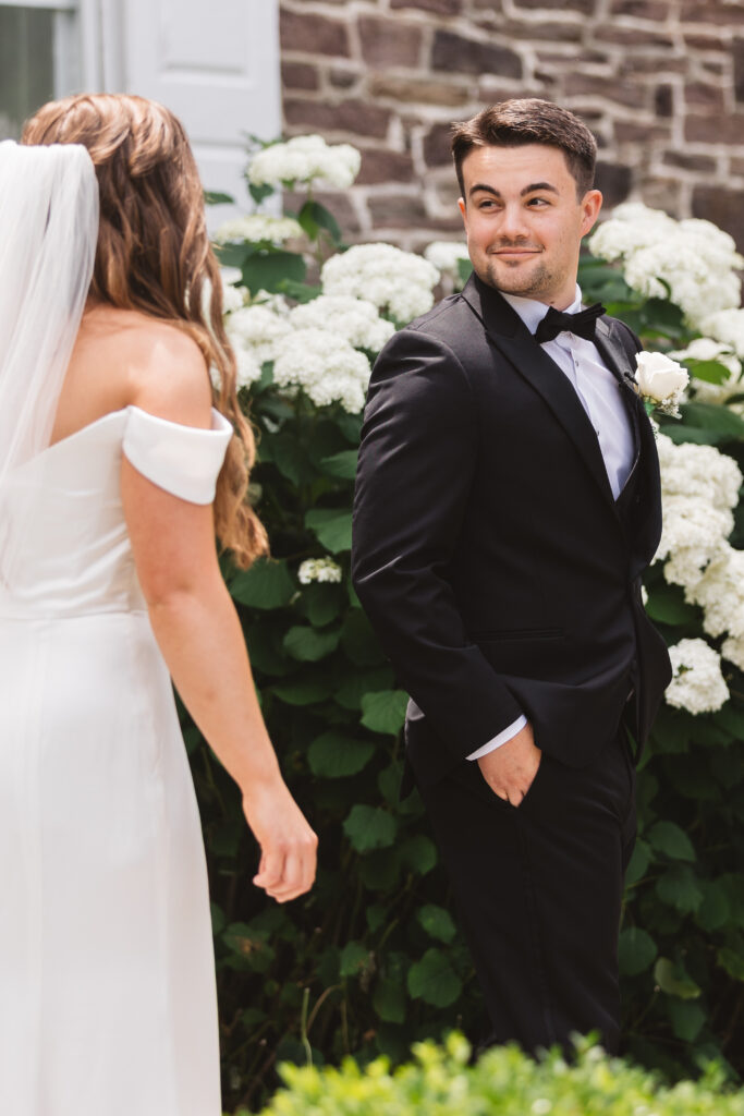 First look photo from behind the bride, photographed by New Jersey and Philadelphia based travel wedding photographer Madison Neumann Photography.