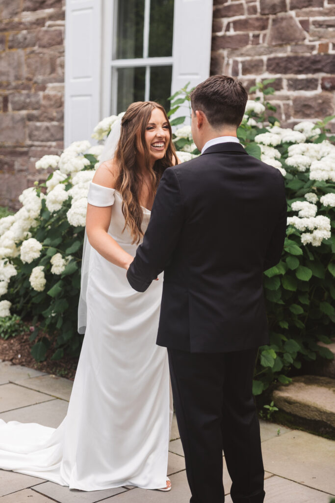 Bride and groom holding hands and smiling during first look, photographed by New Jersey and Philadelphia based travel wedding photographer Madison Neumann Photography.