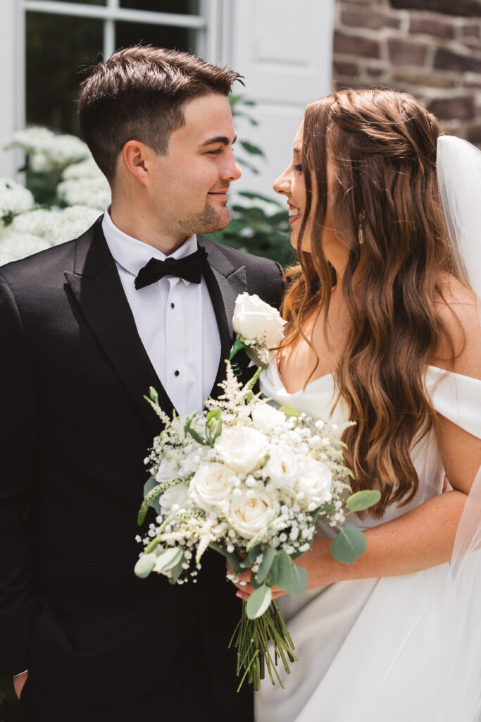 Close up of bride and groom smiling at each other, photographed by New Jersey and Philadelphia based travel wedding photographer Madison Neumann Photography.