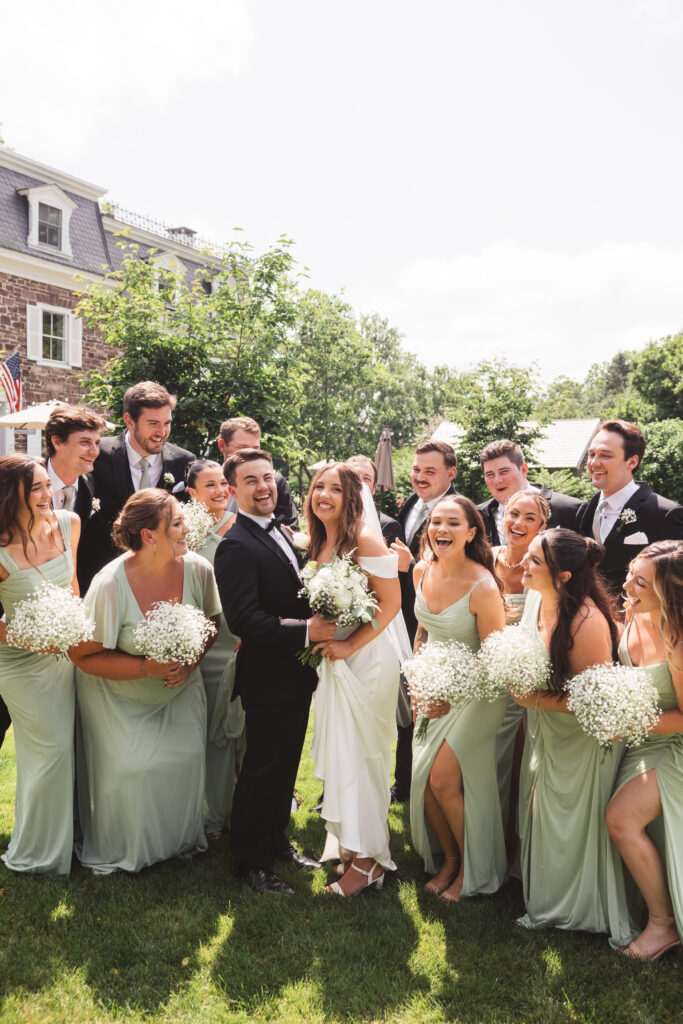 Bridal party laughing and smiling with the happy couple before the ceremony, photographed by New Jersey and Philadelphia based travel wedding photographer Madison Neumann Photography.