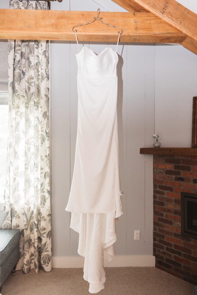 Bride's dress hanging in bridal suite at Woolverton Inn, photographed by New Jersey and Philadelphia based travel wedding photographer Madison Neumann Photography.