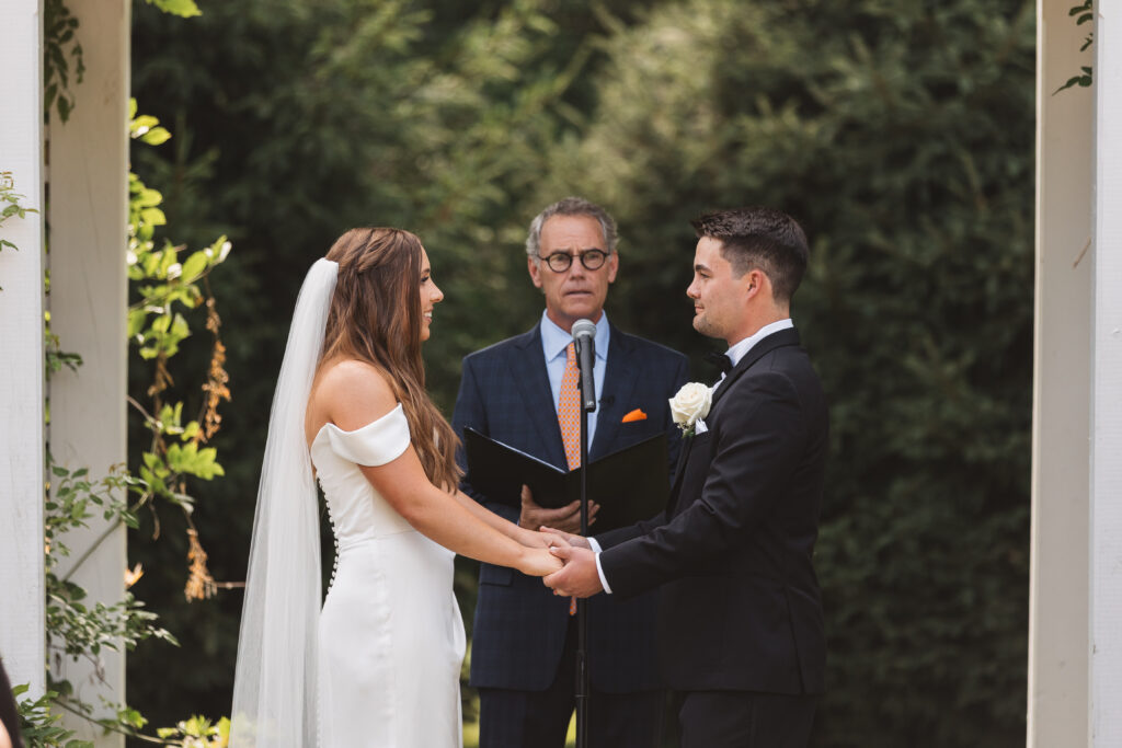 Bride and groom at the alter during the ceremony at The Woolverton Inn, photographed by New Jersey and Philadelphia based travel wedding photographer Madison Neumann Photography.