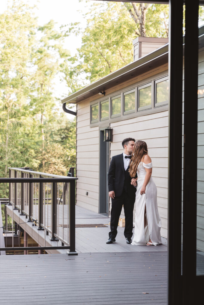 The newly-weds sharing a kiss before their entrance to the reception barn, photographed by New Jersey and Philadelphia based travel wedding photographer Madison Neumann Photography.