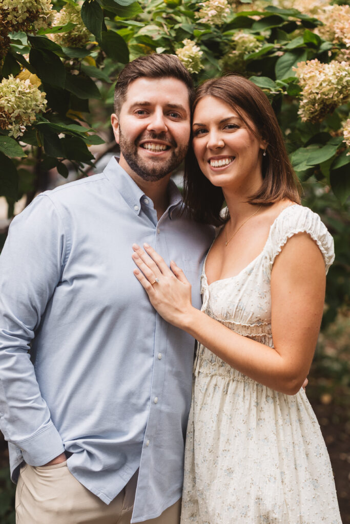 Portrait of couple in the park surrounded by trees and flowers, photographed by Philadelphia and New Jersey based travel wedding photographer, Madison Neumann Photography.