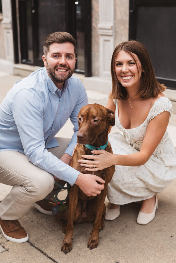 Newly engaged couple on Jewelers row in Philadelphia with their beloved dog Moose, photographed by Philadelphia and New Jersey based travel wedding photographer, Madison Neumann Photography.