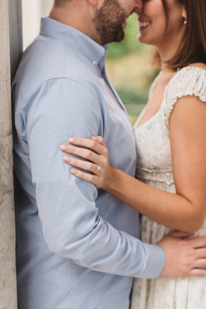 Focused photo of future bride's hand and engagement ring as the couple holds one another, photographed by Philadelphia and New Jersey based travel wedding photographer, Madison Neumann Photography.