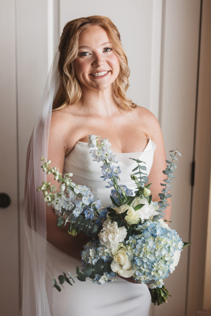 Solo portrait of bride with veil and bouquet with white roses and hydrangeas, photographed by New Jersey and Philadelphia based travel wedding photographer, Madison Neumann Photography.