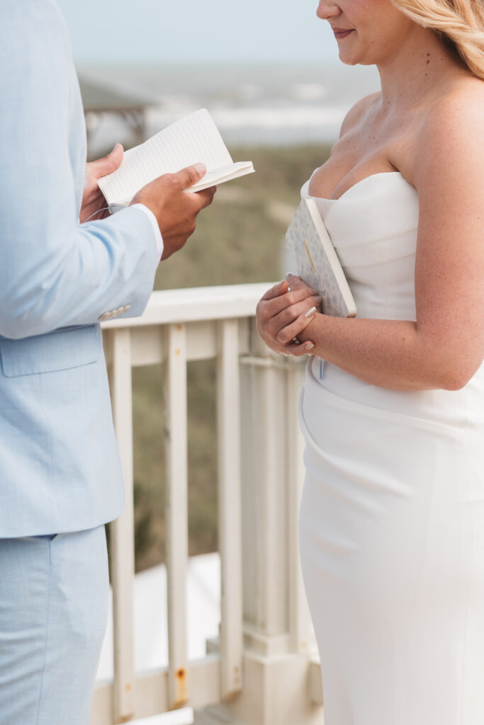 Groom reading his hand-written vows to the bride alone on the balcony, photographed by New Jersey and Philadelphia based travel wedding photographer, Madison Neumann Photography.