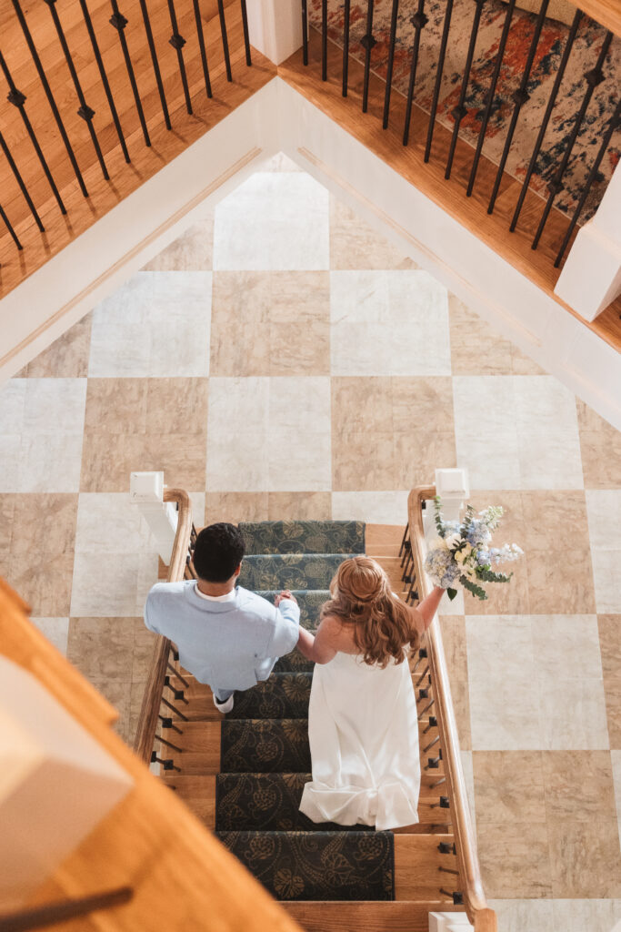 Overhead shot of bride and groom walking down the stairs, photographed by New Jersey and Philadelphia based travel wedding photographer, Madison Neumann Photography.