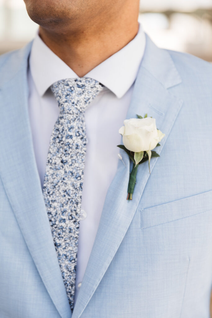 Up close photo of grooms light blue suit with boutonniere, photographed by New Jersey and Philadelphia based travel wedding photographer, Madison Neumann Photography.