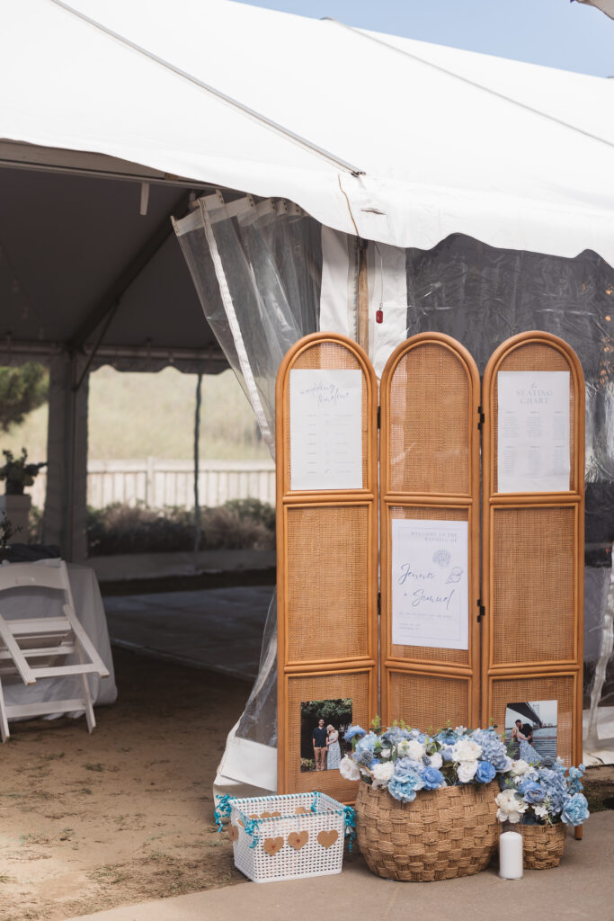 Welcoming information and sign for the ceremony with flowers and photos of the couple, photographed by New Jersey and Philadelphia based travel wedding photographer, Madison Neumann Photography.