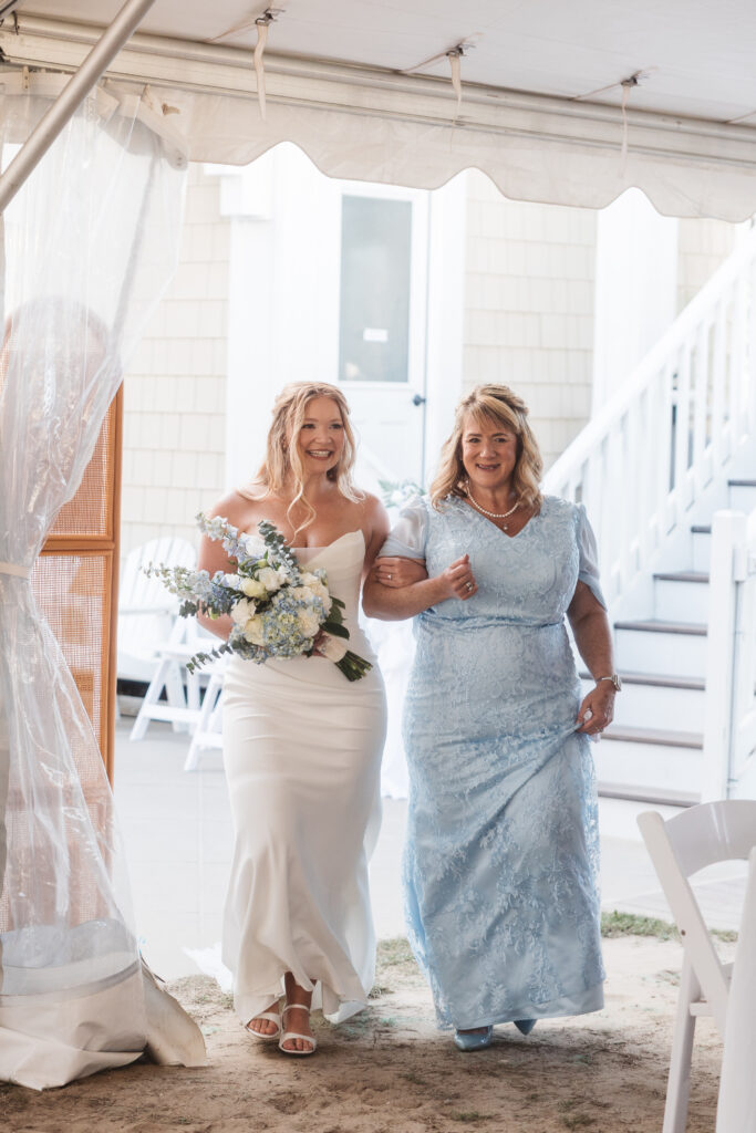 Bride walking down the aisle with her mother, both smiling happily, photographed by New Jersey and Philadelphia based travel wedding photographer, Madison Neumann Photography.