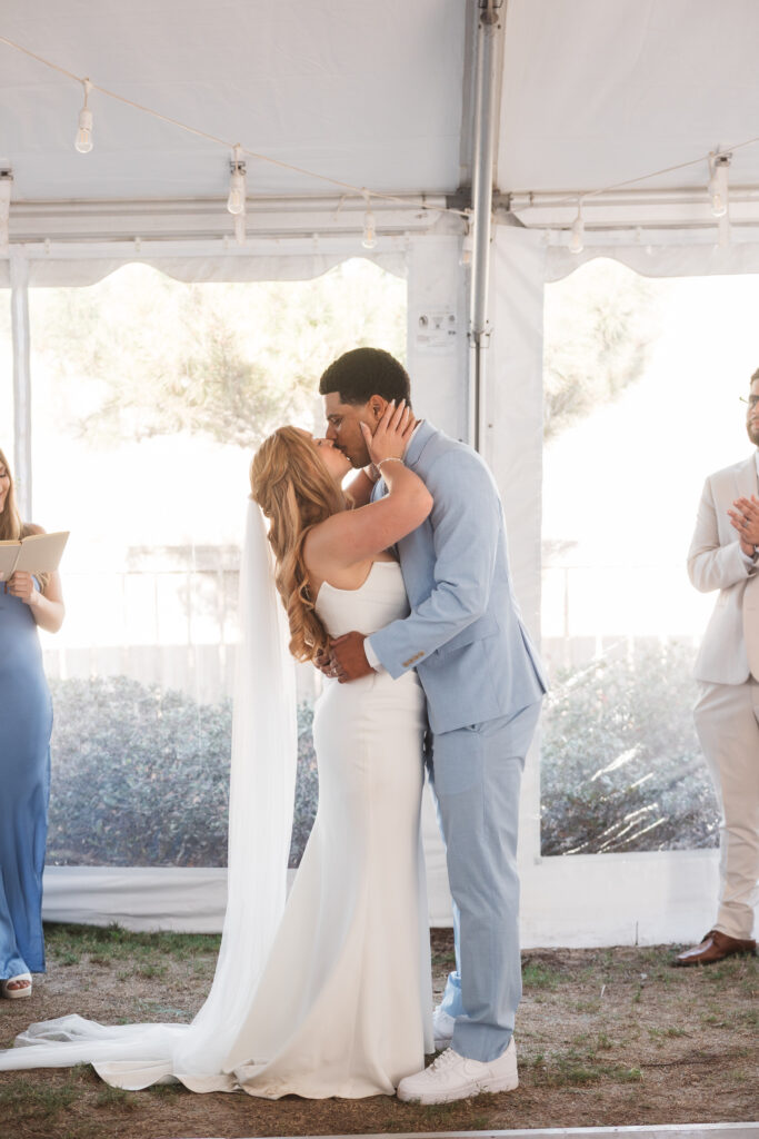 Bride and grooms first kiss as a married couple, photographed by New Jersey and Philadelphia based travel wedding photographer, Madison Neumann Photography.