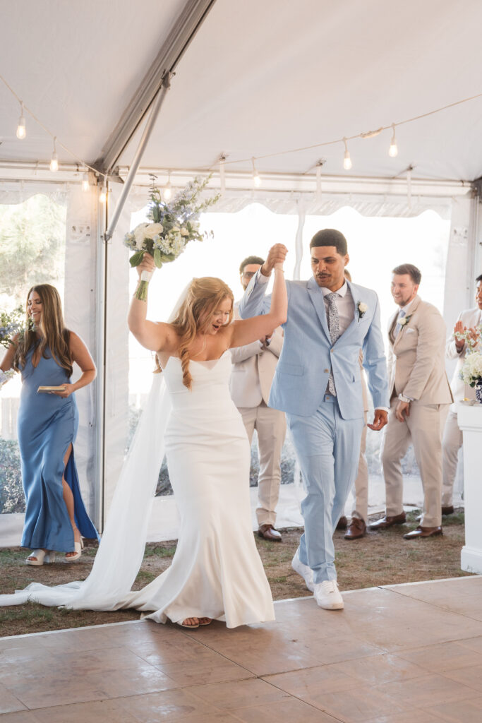 Bride and groom excitingly exiting the ceremony with their hands in the air, photographed by New Jersey and Philadelphia based travel wedding photographer, Madison Neumann Photography.