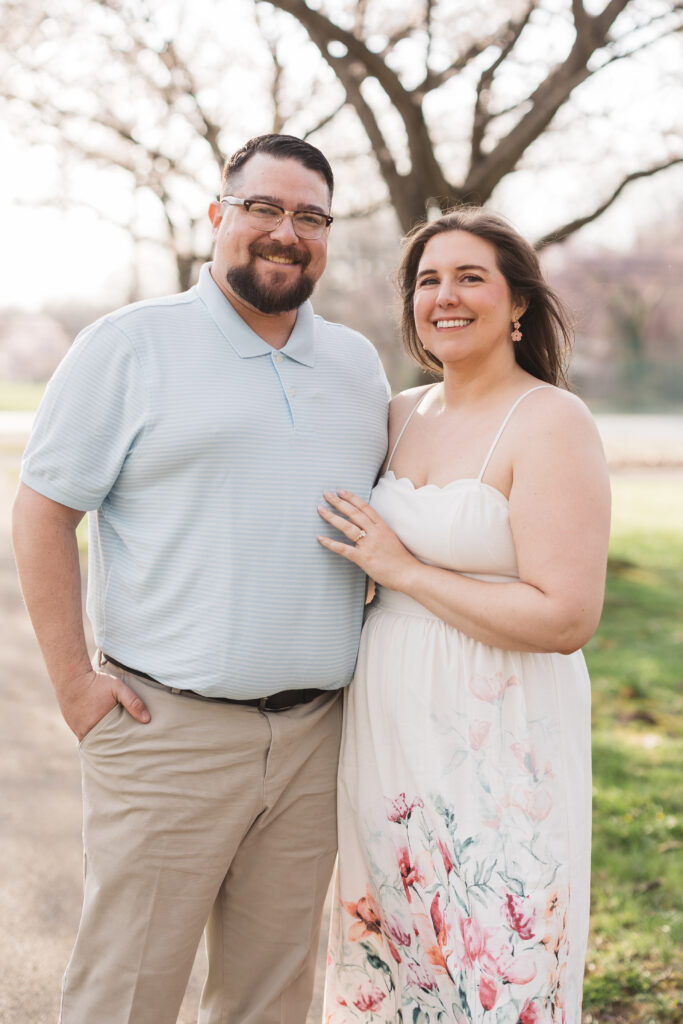 Happy couple in Fairmont park standing side by side and smiling at the camera, photographed by Philadelphia and New Jersey based travel wedding photographer, Madison Neumann Photography.