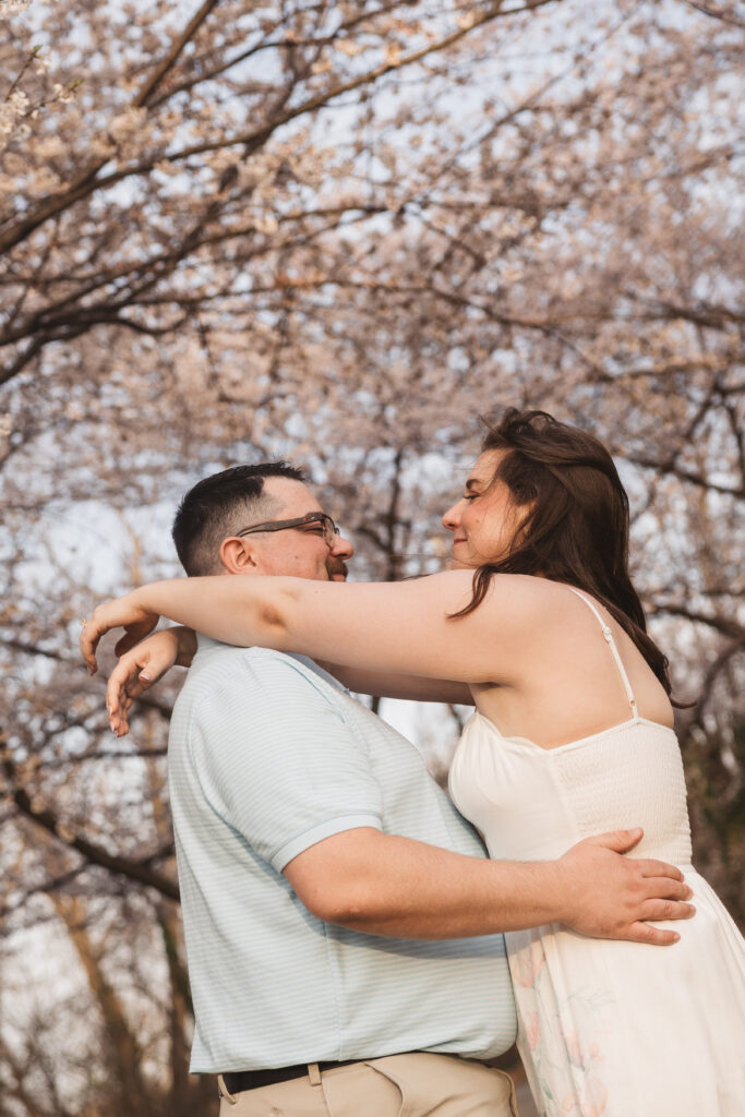 Romantic photo of bride with her hands on her grooms shoulders and smiling at each other as the wind blows, photographed by Philadelphia and New Jersey based travel wedding photographer, Madison Neumann Photography.