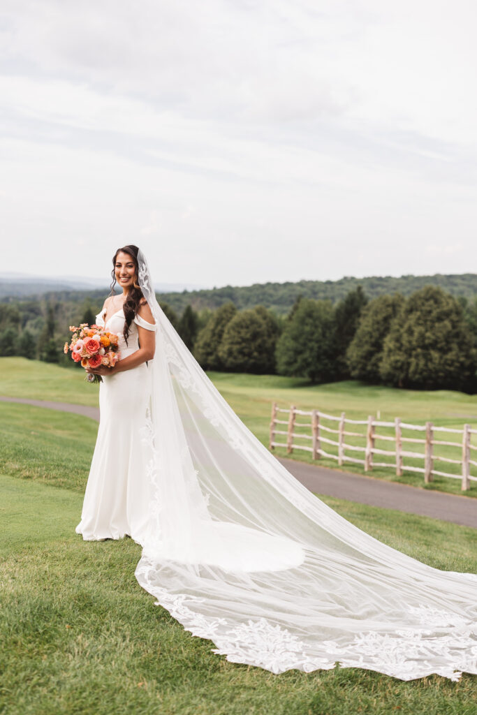 Portrait of bride and her veil on the golf course, photographed by Philadelphia and New Jersey based travel wedding photographer, Madison Neumann Photography.