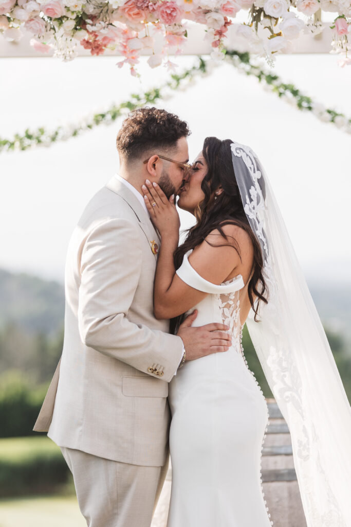 Bride and Grooms first kiss and Mr. and Mrs., photographed by Philadelphia and New Jersey based travel wedding photographer, Madison Neumann Photography.