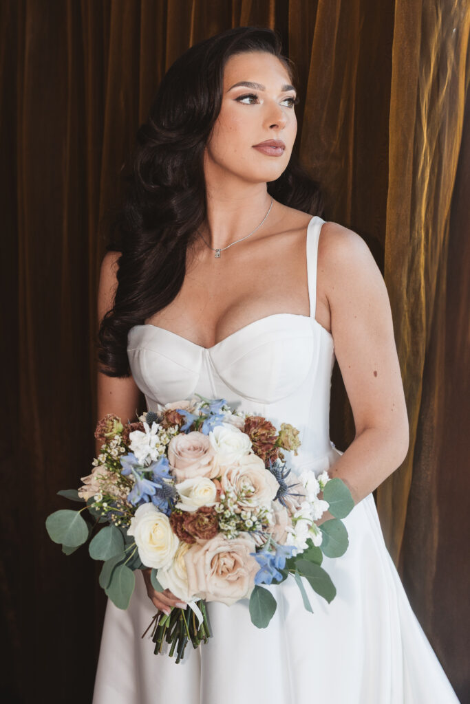 Portrait of the beautiful bride holding her bouquet and looking off to the side, photographed by Philadelphia and New Jersey based travel wedding photographer, Madison Neumann Photography.