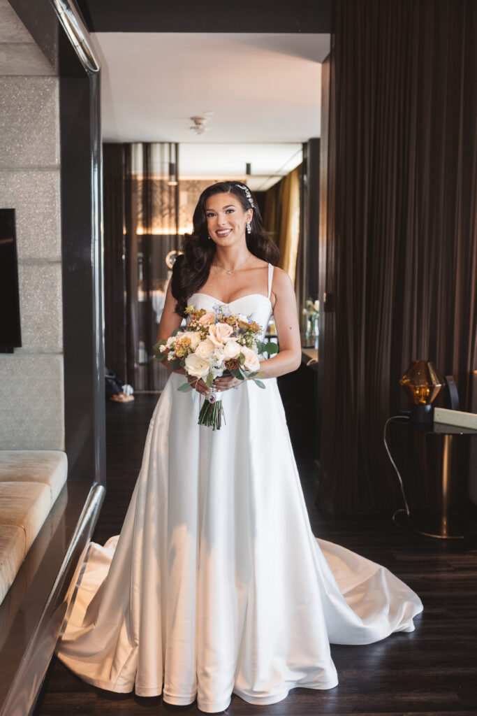 Stunning Portrait of the bride holding her bouquet in her bridal suite before the first look, photographed by Philadelphia and New Jersey based travel wedding photographer, Madison Neumann Photography.