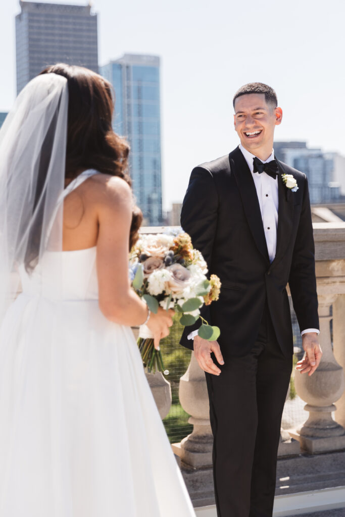 First look from behind the bride with a very happy groom looking at his wife, photographed by Philadelphia and New Jersey based travel wedding photographer, Madison Neumann Photography.