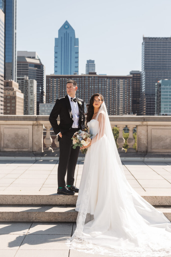 Portrait of bride and groom looking stunning with the beautiful city scape in the background, photographed by Philadelphia and New Jersey based travel wedding photographer, Madison Neumann Photography.