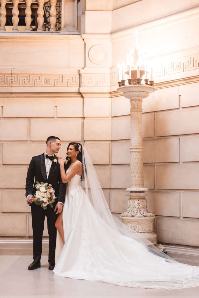 Bride and groom posed with bride holding grooms shoulder as they smile at one another, photographed by Philadelphia and New Jersey based travel wedding photographer, Madison Neumann Photography.