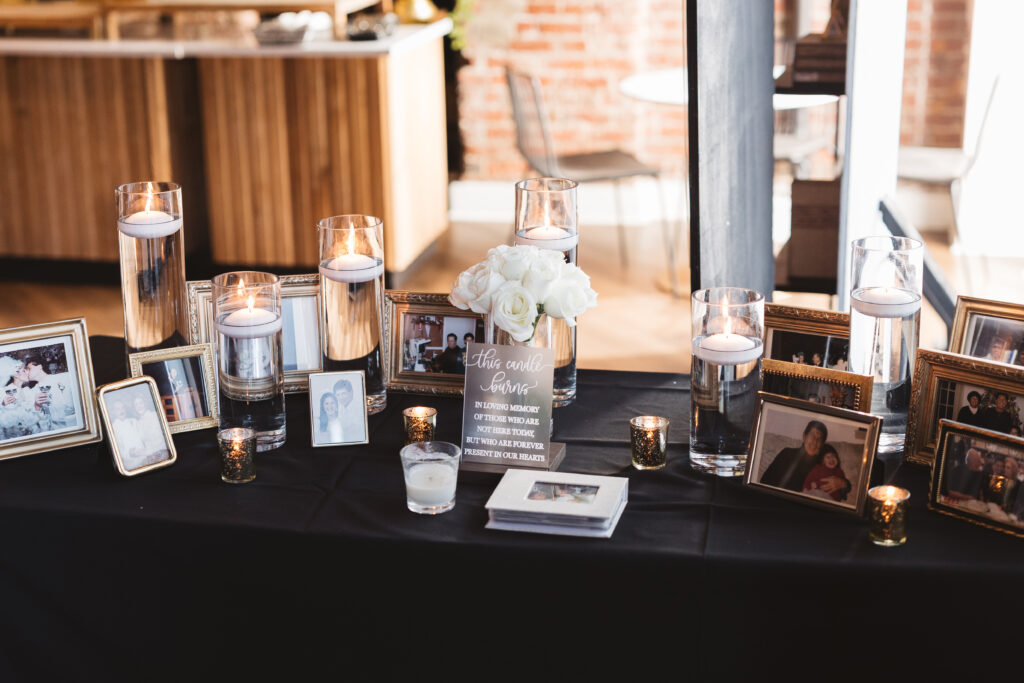 Table of remembrance at the venue filled with pictures of loved ones who couldn't be there to celebrate the couples big day, photographed by Philadelphia and New Jersey based travel wedding photographer, Madison Neumann Photography.