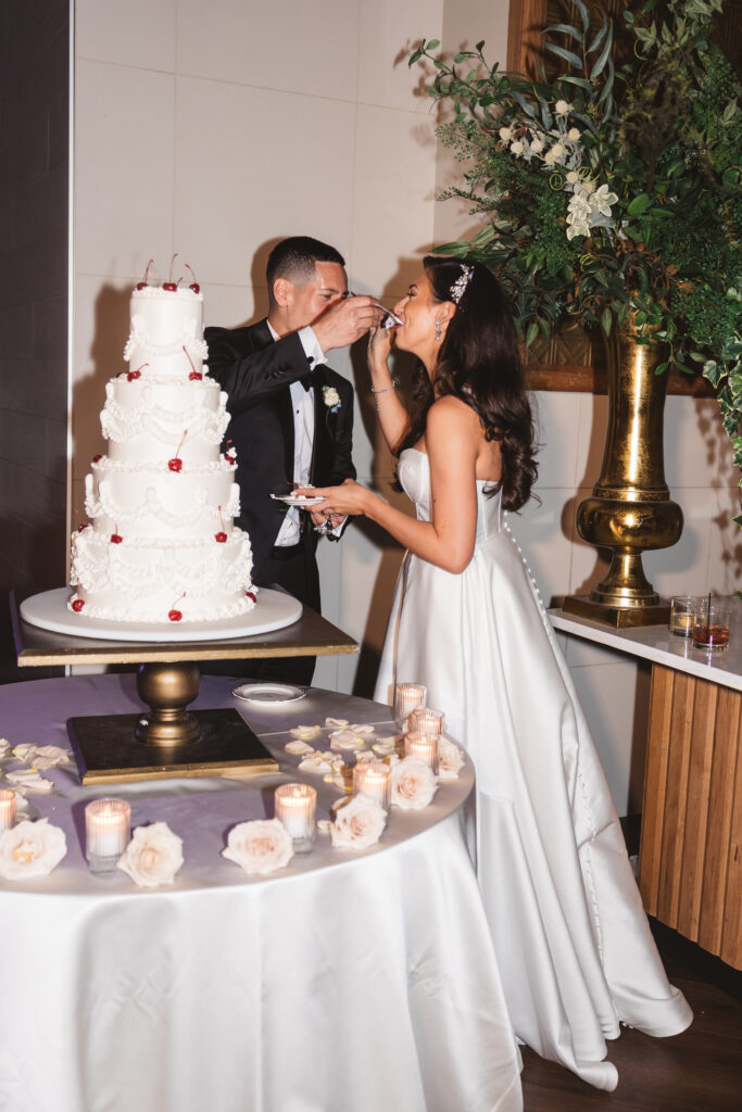 Groom feeds the bride her forkful of cake as she tries to keep from laughing, photographed by Philadelphia and New Jersey based travel wedding photographer, Madison Neumann Photography.