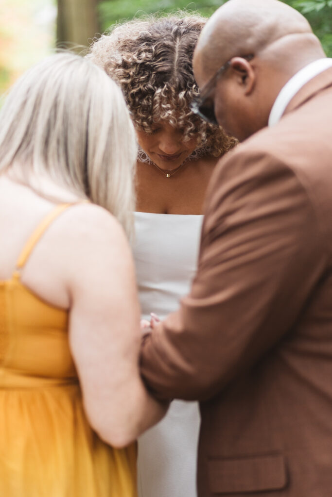 Bride and her parents take a moment to pray together before making their way down the aisle, photographed by Philadelphia and New Jersey based travel wedding photographer, Madison Neumann Photography.