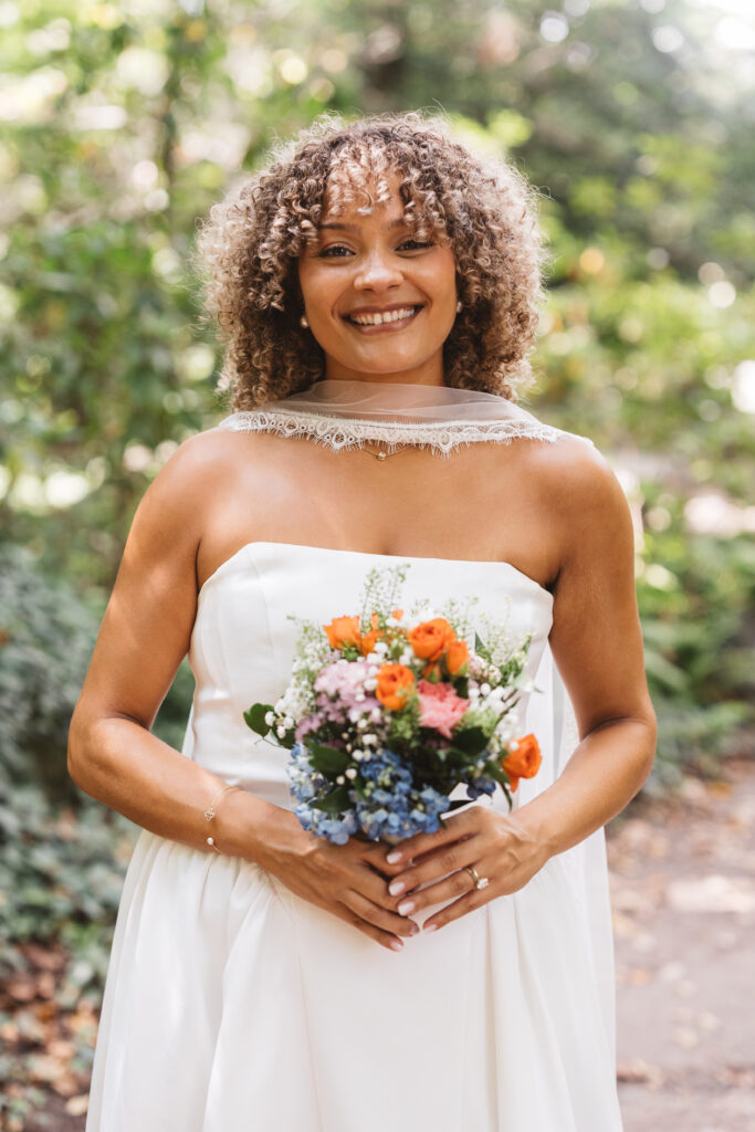 Portrait of the beautiful bride smiling and holding her bouquet, photographed by Philadelphia and New Jersey based travel wedding photographer, Madison Neumann Photography.