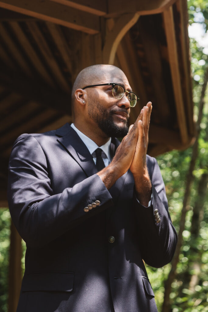 Groom waiting at the gazebo for his lovely bride with praying hands, photographed by Philadelphia and New Jersey based travel wedding photographer, Madison Neumann Photography.