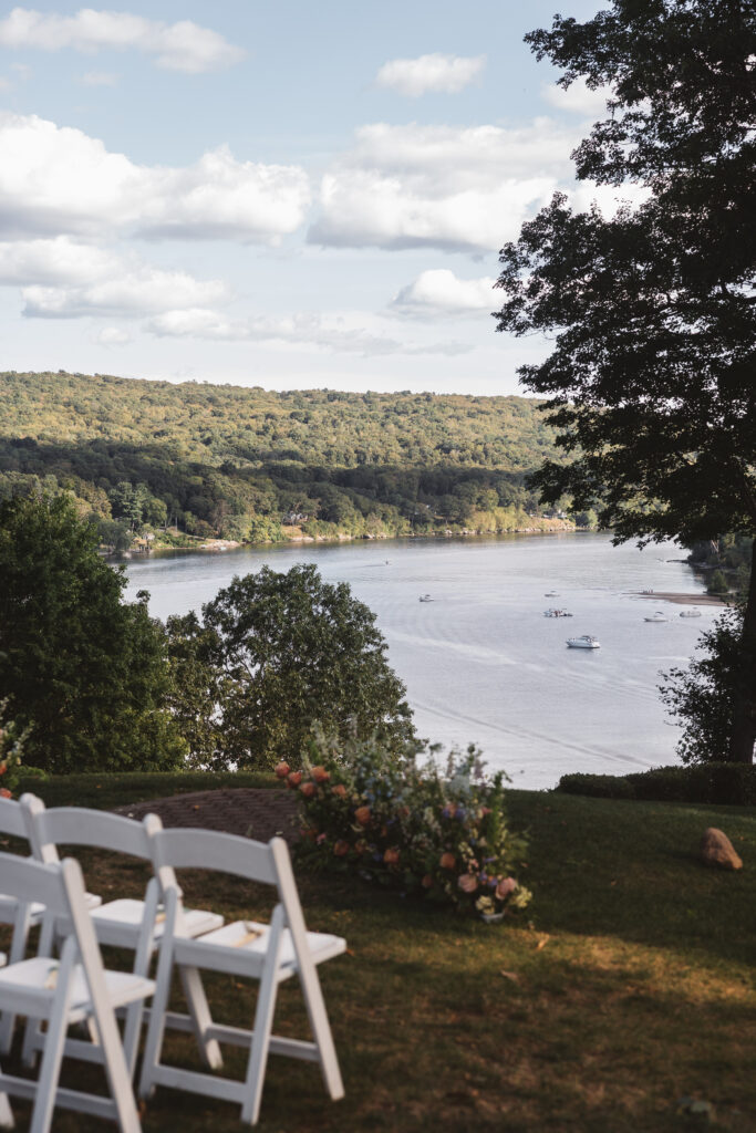 Shot from the venue overlooking the water with tons of boats and shadows of the clouds on the rolling hills, photographed by Philadelphia and New Jersey based travel wedding photographer, Madison Neumann Photography.