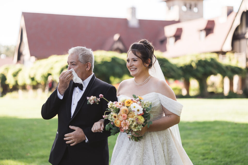 Bride walks down the aisle with her emotional father arm in arm, photographed by Philadelphia and New Jersey based travel wedding photographer, Madison Neumann Photography.