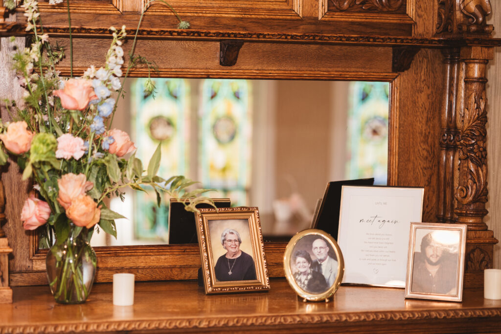 Remembrance table at the reception with photos of loved ones who could not be with the couple for their special day and a vase of flowers, photographed by Philadelphia and New Jersey based travel wedding photographer, Madison Neumann Photography.