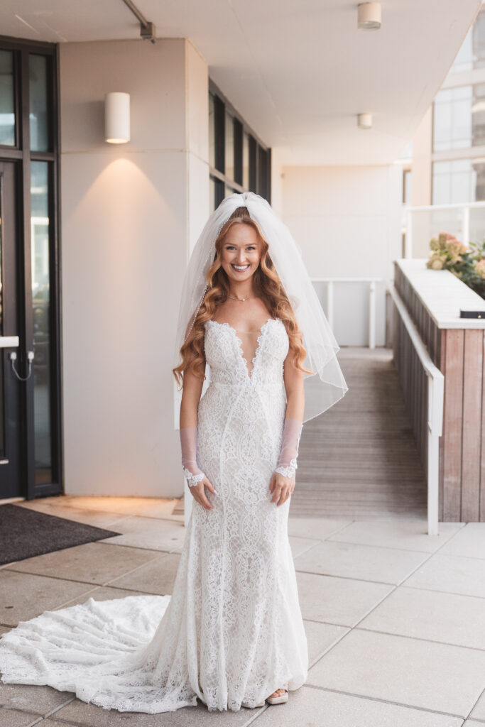 Portrait of the bride in her gown with the veil in the pool garden at Wave Resort in Long Branch, NJ, photographed by Philadelphia and New Jersey based travel wedding photographer, Madison Neumann Photography.