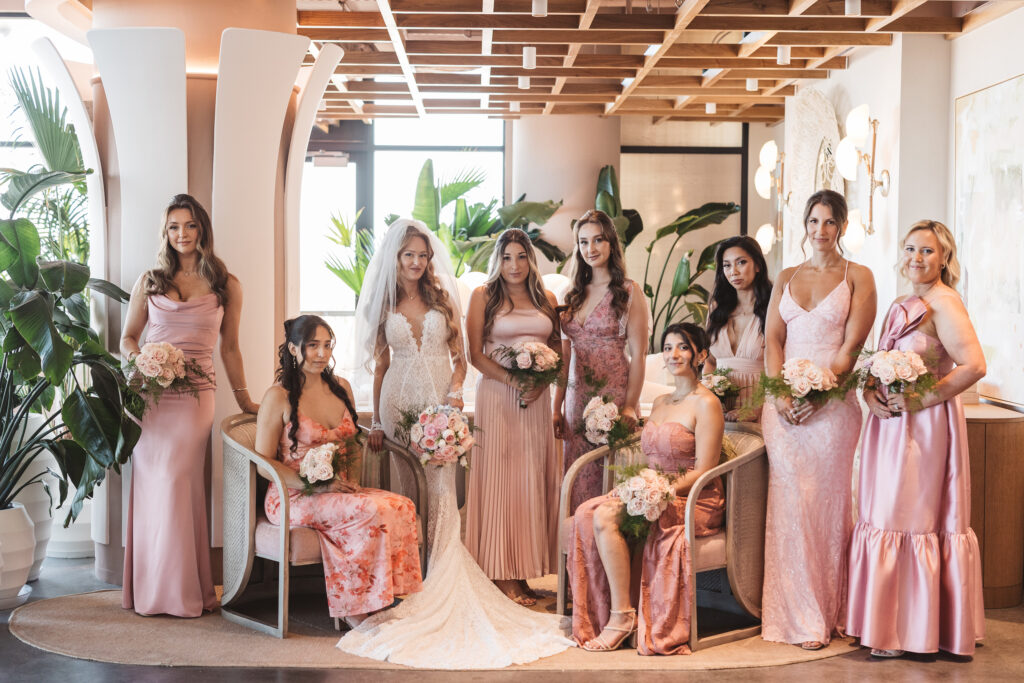 Bride and her bridal party posed artistically in the lobby of the Wave Resort, photographed by Philadelphia and New Jersey based travel wedding photographer, Madison Neumann Photography.