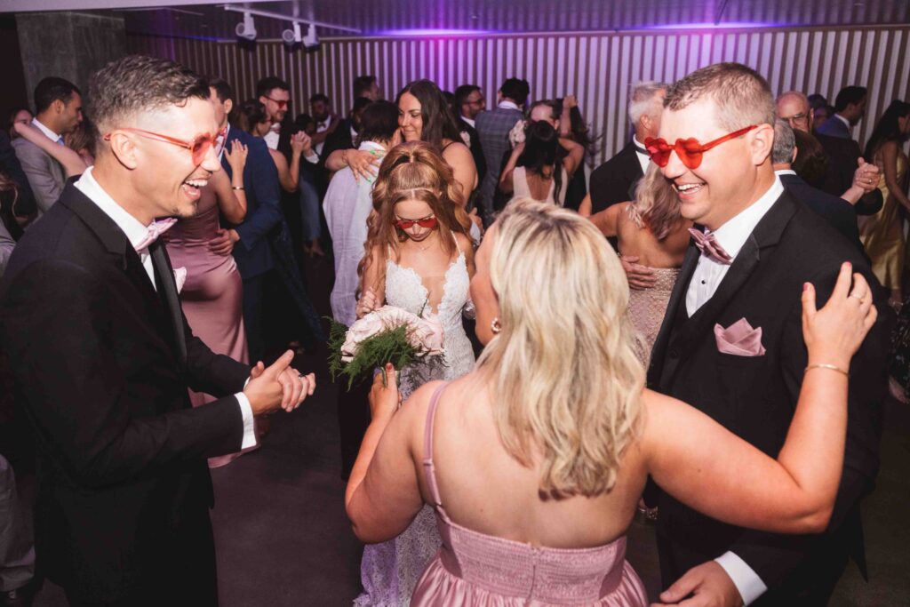 Bride and groom on the dance floor with friends and family, photographed by Philadelphia and New Jersey based travel wedding photographer, Madison Neumann Photography.