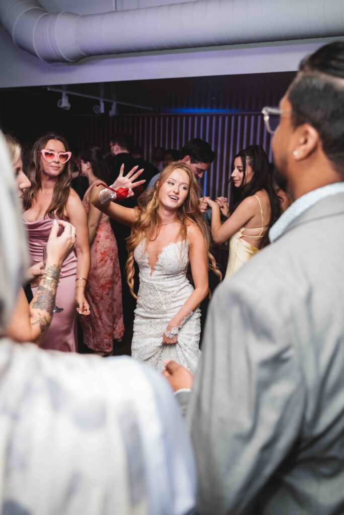 Bride dancing in the circle surrounded by loved ones on the dance floor, photographed by Philadelphia and New Jersey based travel wedding photographer, Madison Neumann Photography.