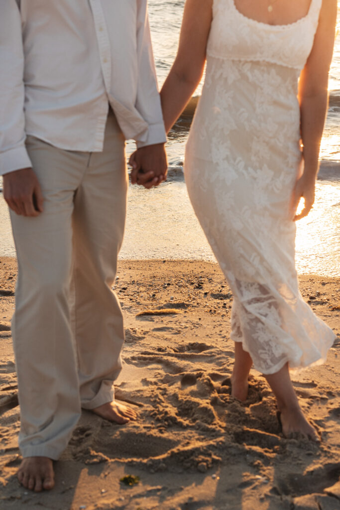 Detail shot of the couples outfits which are neutral and illuminated by the sun reflecting off the water and the sand, photographed by Philadelphia and New Jersey based travel wedding photographer, Madison Neumann Photography.