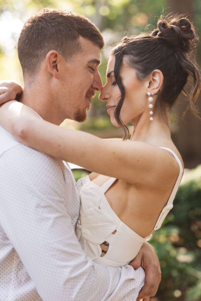 Intimate close up shot of bride and groom touching noses as the hold each other in an embrace in Rittenhouse Square, photographed by Philadelphia and New Jersey based travel wedding photographer, Madison Neumann Photography.
