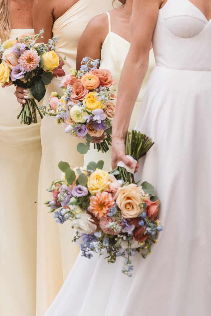 Detail shot of bride and bridesmaids holding their bouquets, photographed by Philadelphia and New Jersey based travel wedding photographer, Madison Neumann Photography.